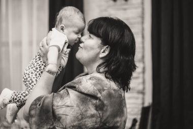 grayscale photo of woman kissing mans cheek